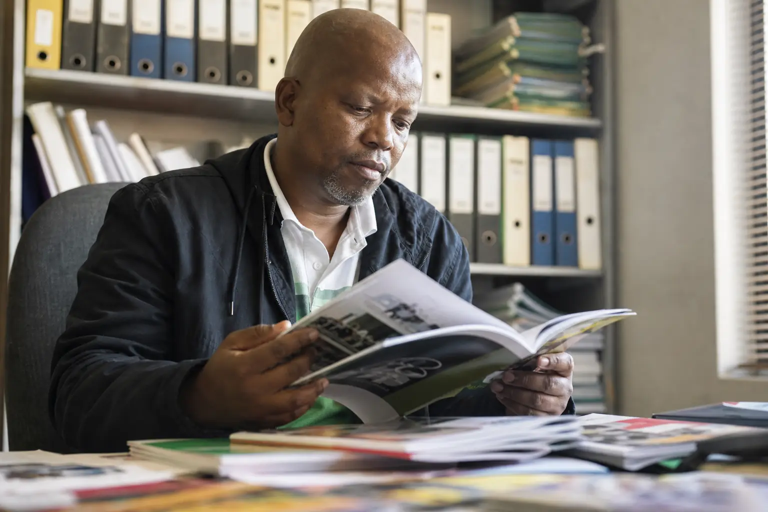 A worker reading union resources and guides